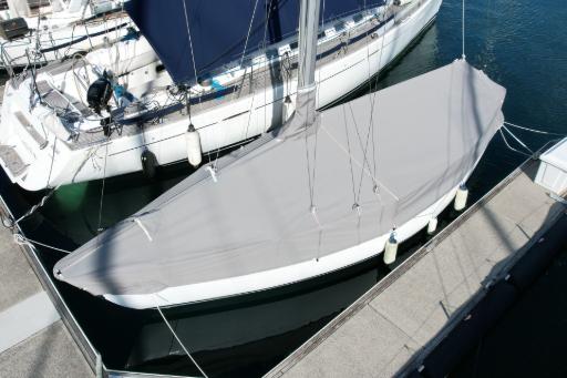 Sailboat at winter lay-up with tape measure and notebook, ready to plan sailboat upgrades